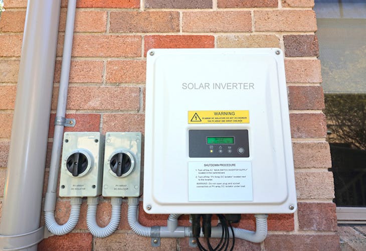 Solar inverter on the side of a house