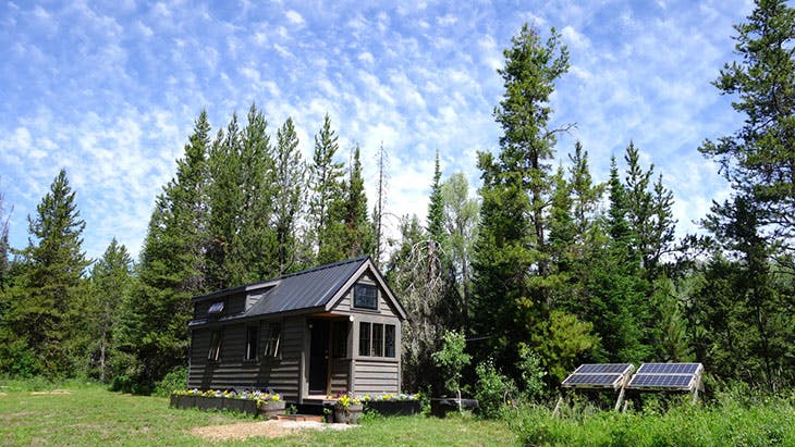 cabin in woods using solar panels