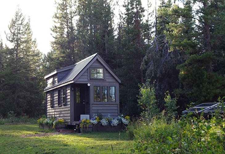 Evening light on a solar powered tiny house in the woods.