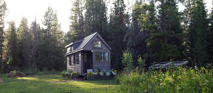 Evening light on a solar powered tiny house in the woods.